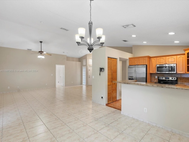 kitchen with decorative backsplash, ceiling fan with notable chandelier, stainless steel appliances, decorative light fixtures, and lofted ceiling