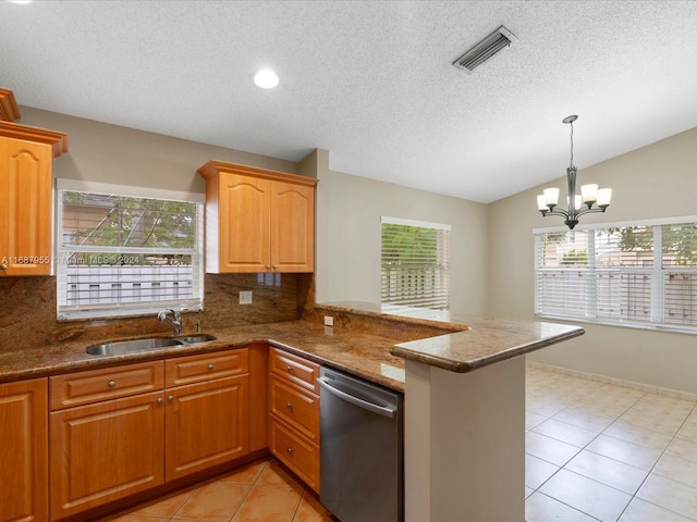 kitchen featuring kitchen peninsula, dishwasher, and a healthy amount of sunlight