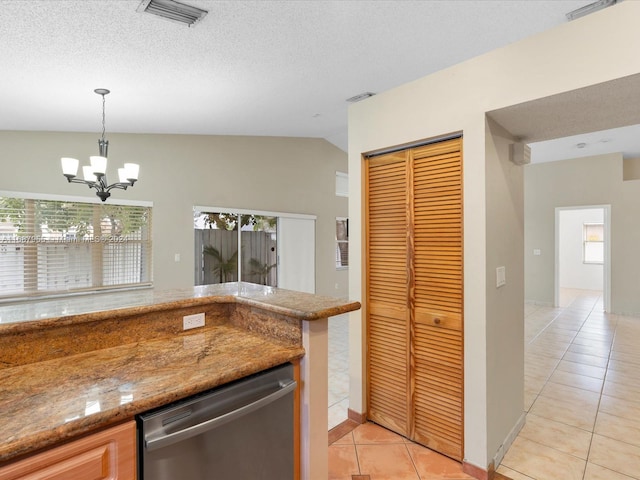 kitchen featuring dishwasher, an inviting chandelier, light tile patterned floors, and vaulted ceiling