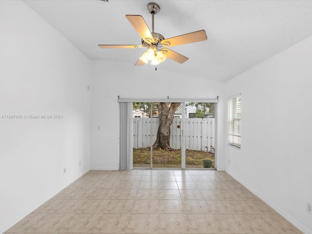 unfurnished room with light tile patterned floors, ceiling fan, and lofted ceiling