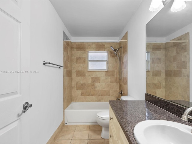 full bathroom with tiled shower / bath, tile patterned flooring, vanity, and toilet