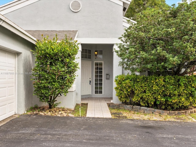 view of exterior entry featuring a garage