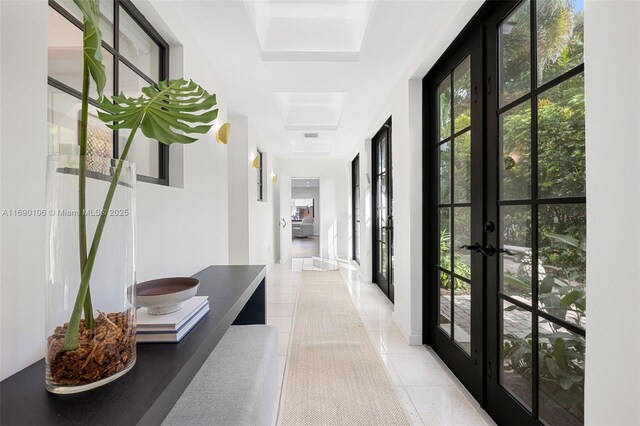 hallway with french doors and tile patterned flooring