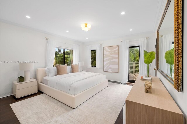 bedroom with multiple windows, ornamental molding, hardwood / wood-style flooring, and access to exterior