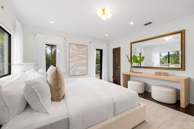 bedroom with hardwood / wood-style flooring and crown molding