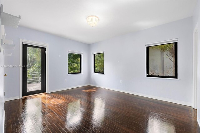 spare room with dark wood-type flooring