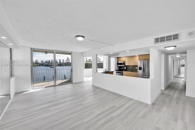 16570 NE 26th Ave Unit 2A, North Miami Beach, FL 33160 - unfurnished living room with light wood-style flooring, a sink, recessed lighting, baseboards, and a water view