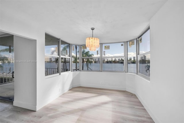 16570 NE 26th Ave Unit 2A, North Miami Beach, FL 33160 - unfurnished sunroom featuring a chandelier and a water view