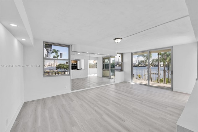 16570 NE 26th Ave Unit 2A, North Miami Beach, FL 33160 - unfurnished room featuring wood finished floors, plenty of natural light, baseboards, and recessed lighting