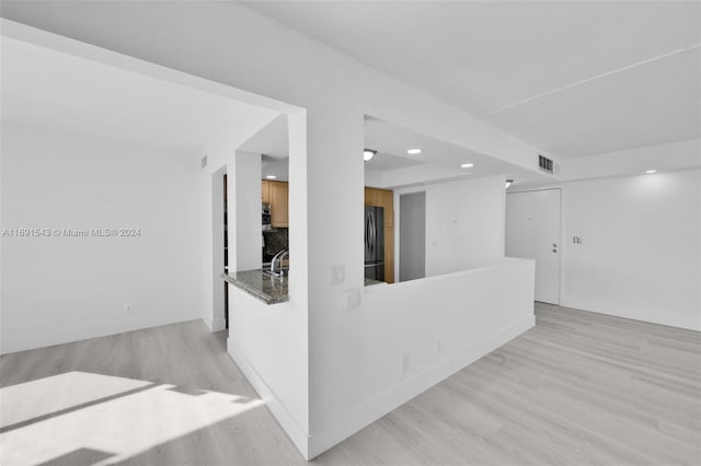 16570 NE 26th Ave Unit 2A, North Miami Beach, FL 33160 - unfurnished living room featuring light wood-style floors and recessed lighting