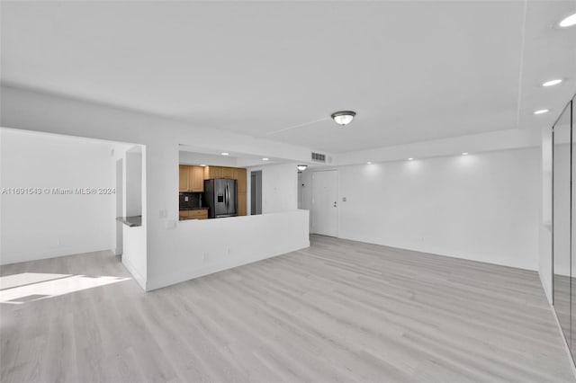 16570 NE 26th Ave Unit 2A, North Miami Beach, FL 33160 - unfurnished living room with recessed lighting and light wood-style flooring