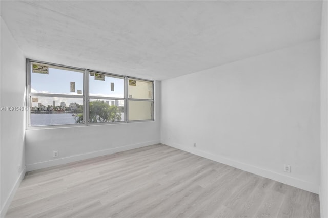 16570 NE 26th Ave Unit 2A, North Miami Beach, FL 33160 - unfurnished room featuring wood finished floors and baseboards