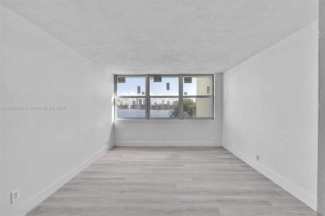 16570 NE 26th Ave Unit 2A, North Miami Beach, FL 33160 - spare room with baseboards and light wood-style flooring