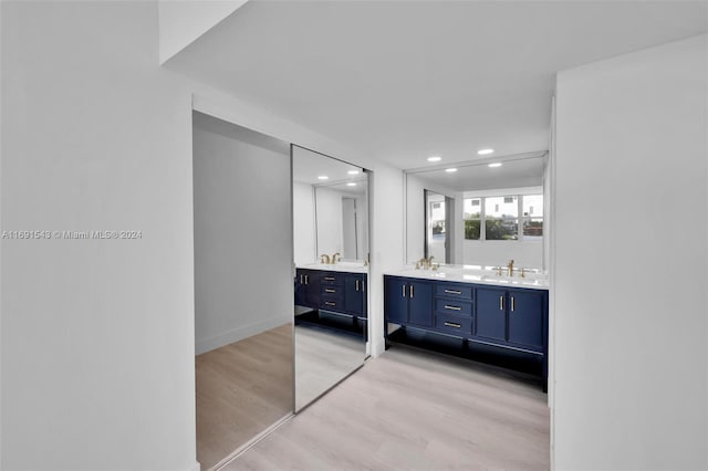 16570 NE 26th Ave Unit 2A, North Miami Beach, FL 33160 - full bath with wood finished floors, double vanity, recessed lighting, and baseboards