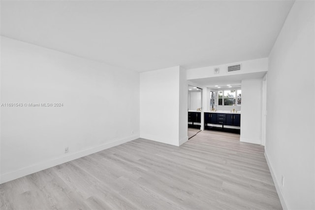 16570 NE 26th Ave Unit 2A, North Miami Beach, FL 33160 - spare room with light wood-type flooring and baseboards