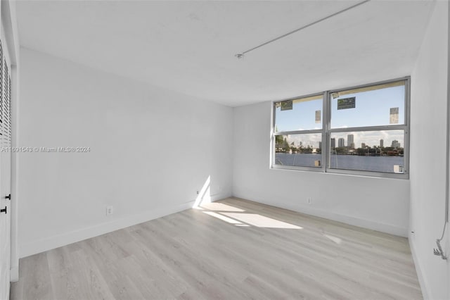 16570 NE 26th Ave Unit 2A, North Miami Beach, FL 33160 - empty room with wood finished floors and baseboards