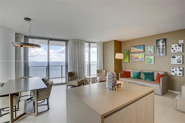 kitchen with a kitchen island, a water view, and floor to ceiling windows