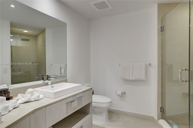 bathroom with a shower with shower door, vanity, and toilet