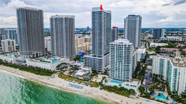 property's view of city with a view of the beach and a water view