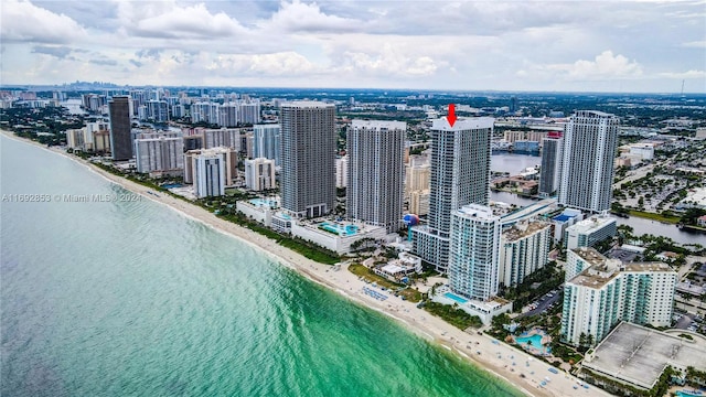 birds eye view of property featuring a view of the beach and a water view