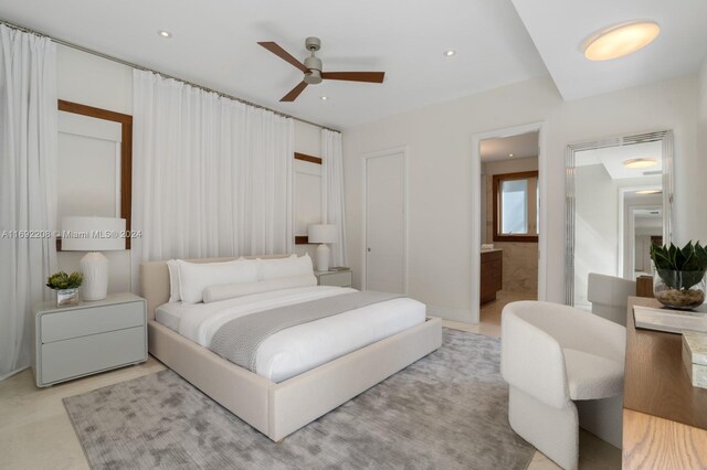 bedroom with ceiling fan and ensuite bath