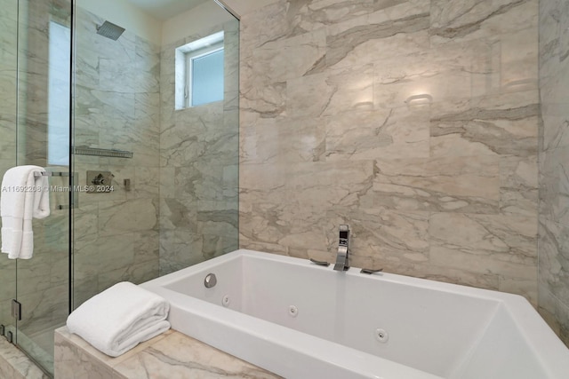 bathroom featuring shower with separate bathtub