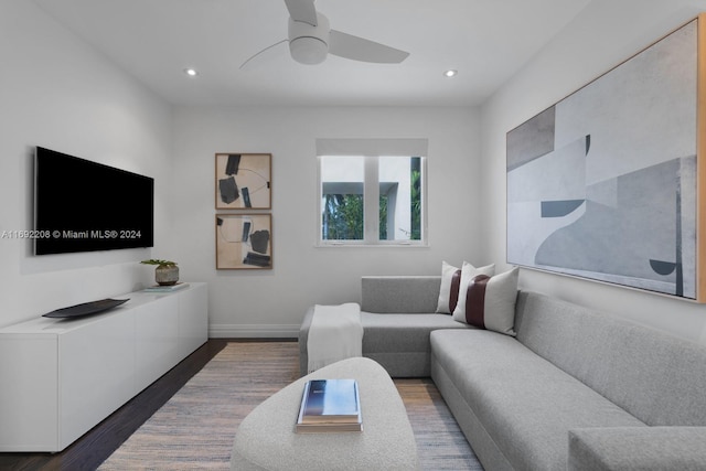 living room with ceiling fan and dark hardwood / wood-style flooring