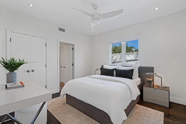 bedroom with ceiling fan, dark hardwood / wood-style floors, and a closet