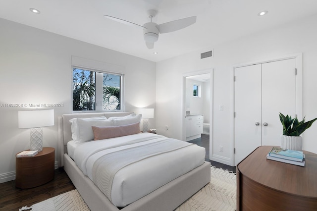 bedroom with hardwood / wood-style flooring, ceiling fan, ensuite bathroom, and a closet