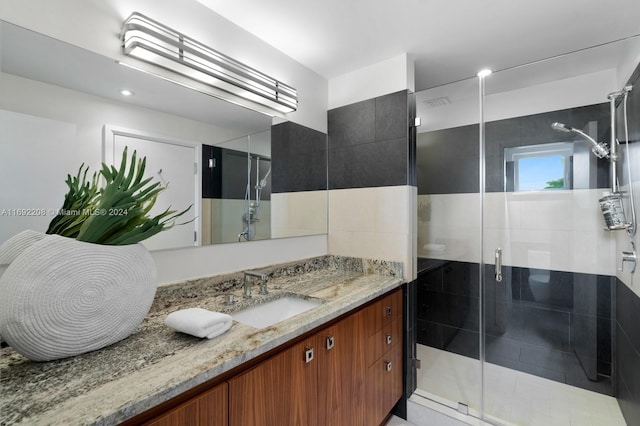 bathroom with vanity and a shower with shower door