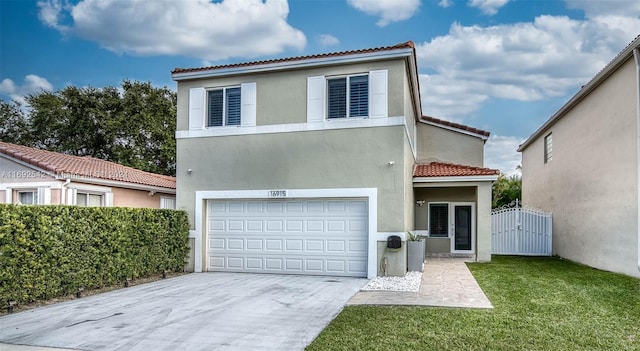 mediterranean / spanish-style home featuring a garage and a front yard