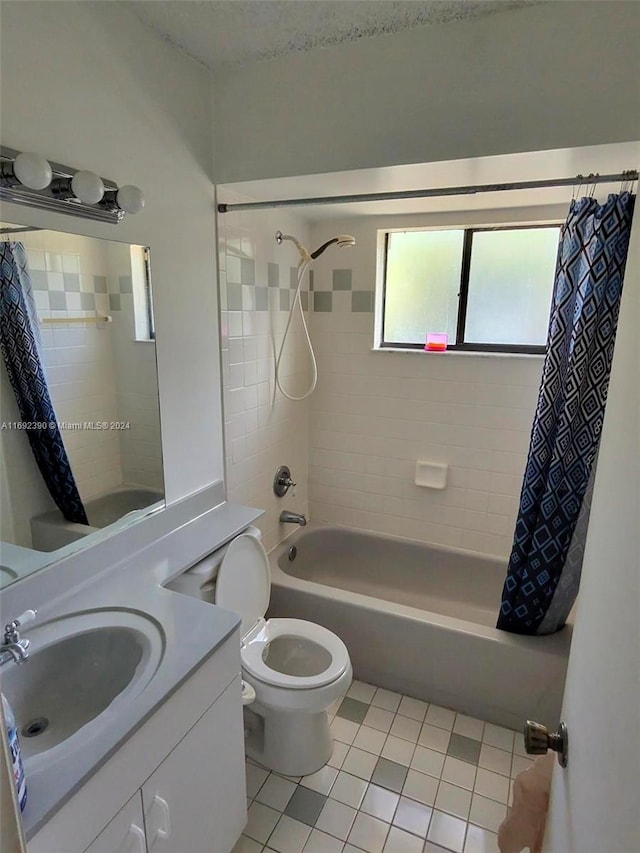 full bathroom with toilet, shower / bath combo, vanity, and tile patterned flooring