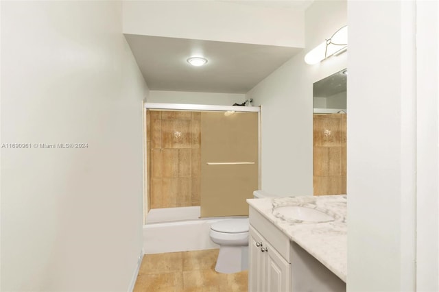 full bathroom featuring tile patterned flooring, vanity, toilet, and tiled shower / bath