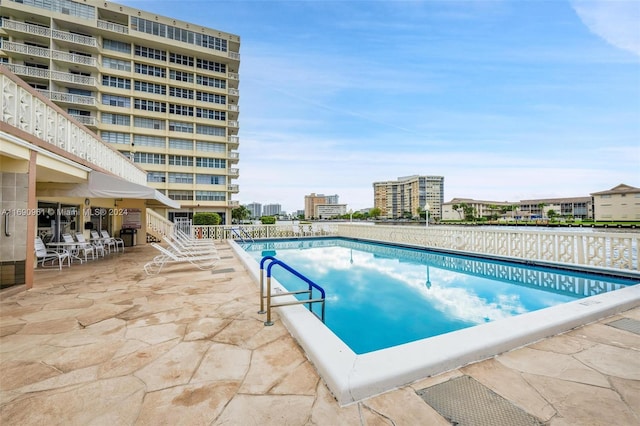 view of swimming pool with a patio