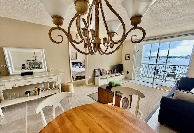 tiled dining room with a textured ceiling and a notable chandelier