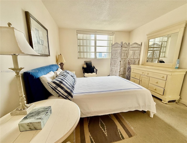 carpeted bedroom featuring a textured ceiling