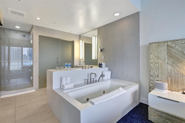 bathroom with tile walls, tile patterned flooring, vanity, and independent shower and bath