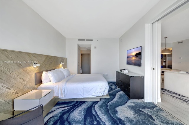 bedroom with wood-type flooring