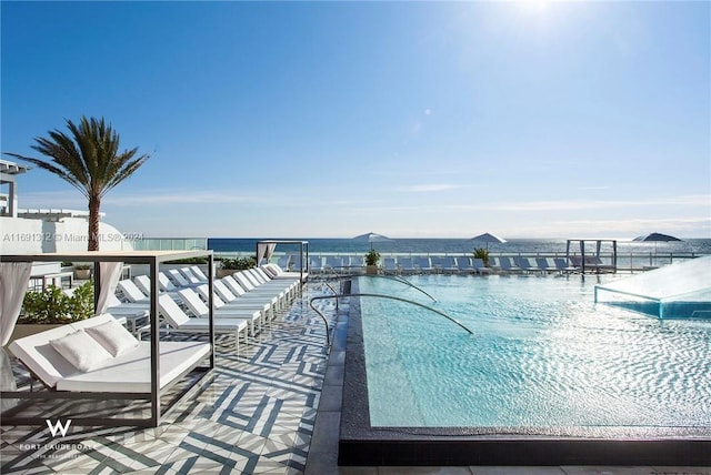 view of swimming pool with a water view