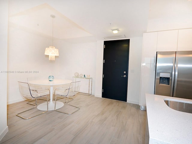 unfurnished dining area with light wood-type flooring