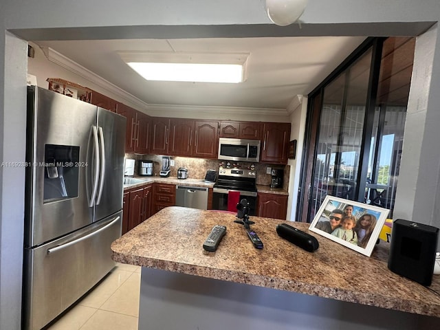 kitchen featuring light tile patterned floors, tasteful backsplash, crown molding, dark brown cabinets, and appliances with stainless steel finishes