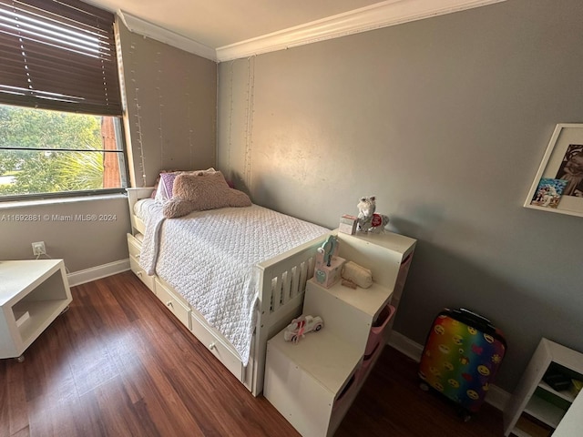 bedroom featuring dark hardwood / wood-style floors and ornamental molding