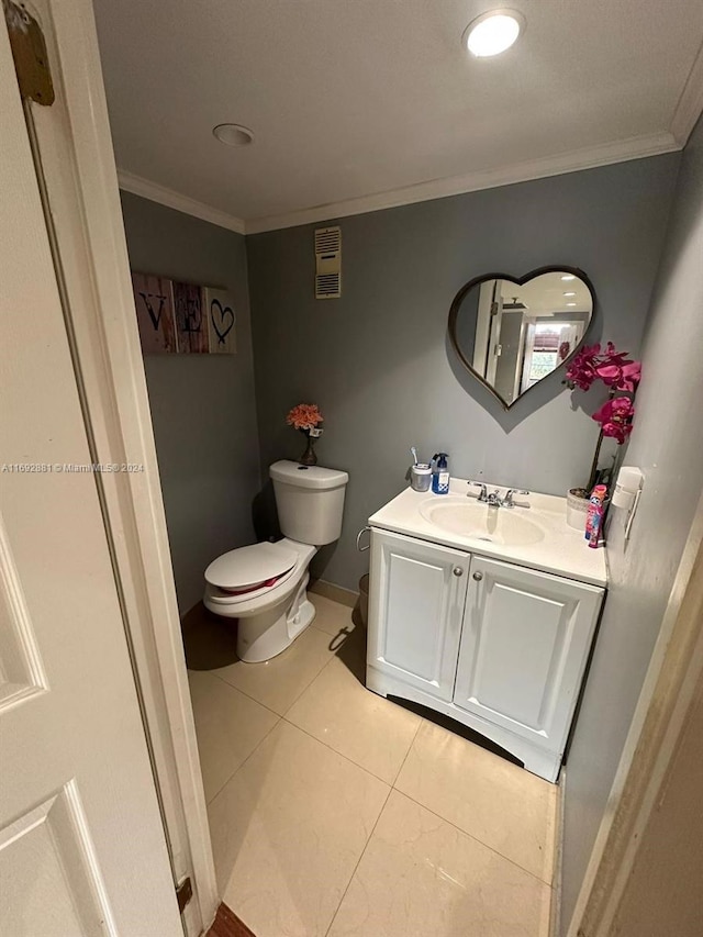 bathroom featuring tile patterned flooring, vanity, toilet, and ornamental molding