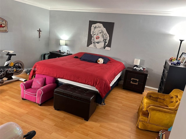 bedroom with hardwood / wood-style flooring and crown molding