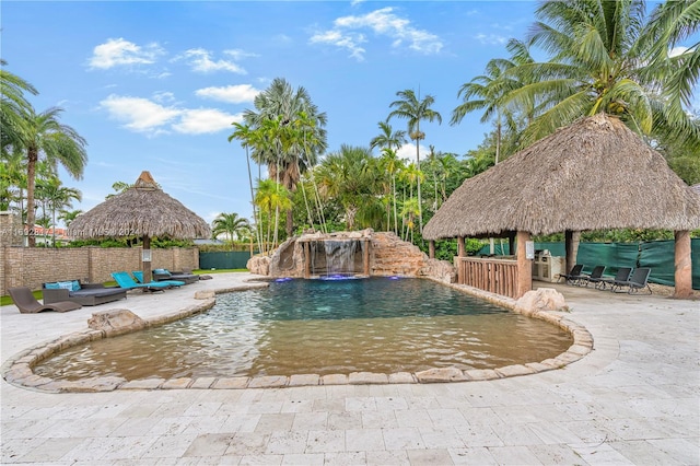 view of swimming pool with a patio area, a gazebo, and pool water feature