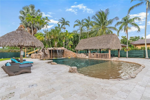 view of swimming pool with a patio, a gazebo, and pool water feature