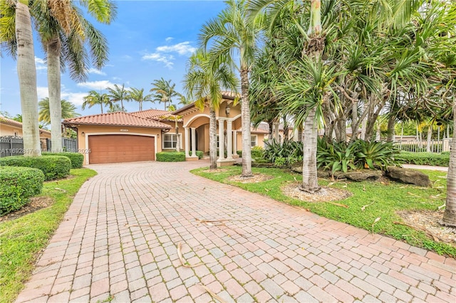 mediterranean / spanish-style house with a garage