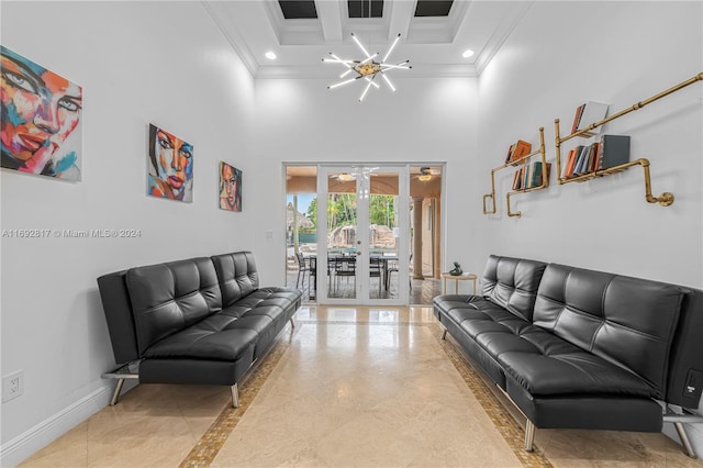 living room featuring a high ceiling, a chandelier, light tile patterned floors, and ornamental molding