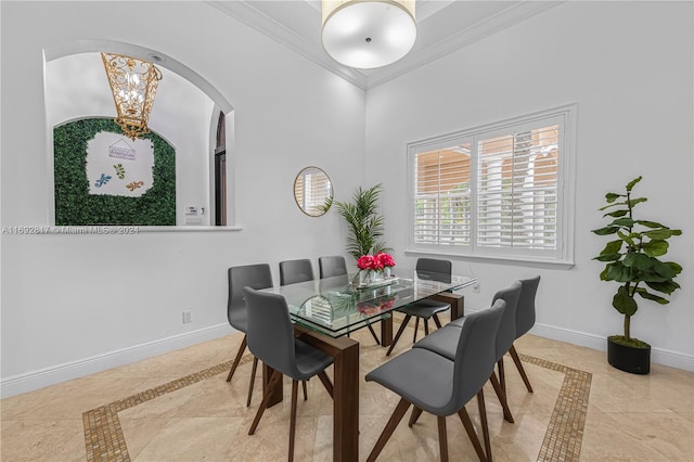 dining space with ornamental molding