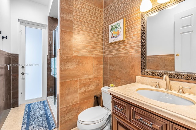 bathroom featuring walk in shower, vanity, toilet, and tile walls